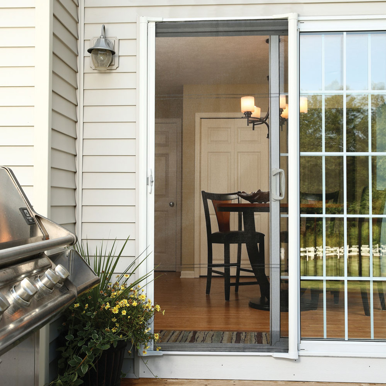 Retractable screen on sliding door with deck furniture
